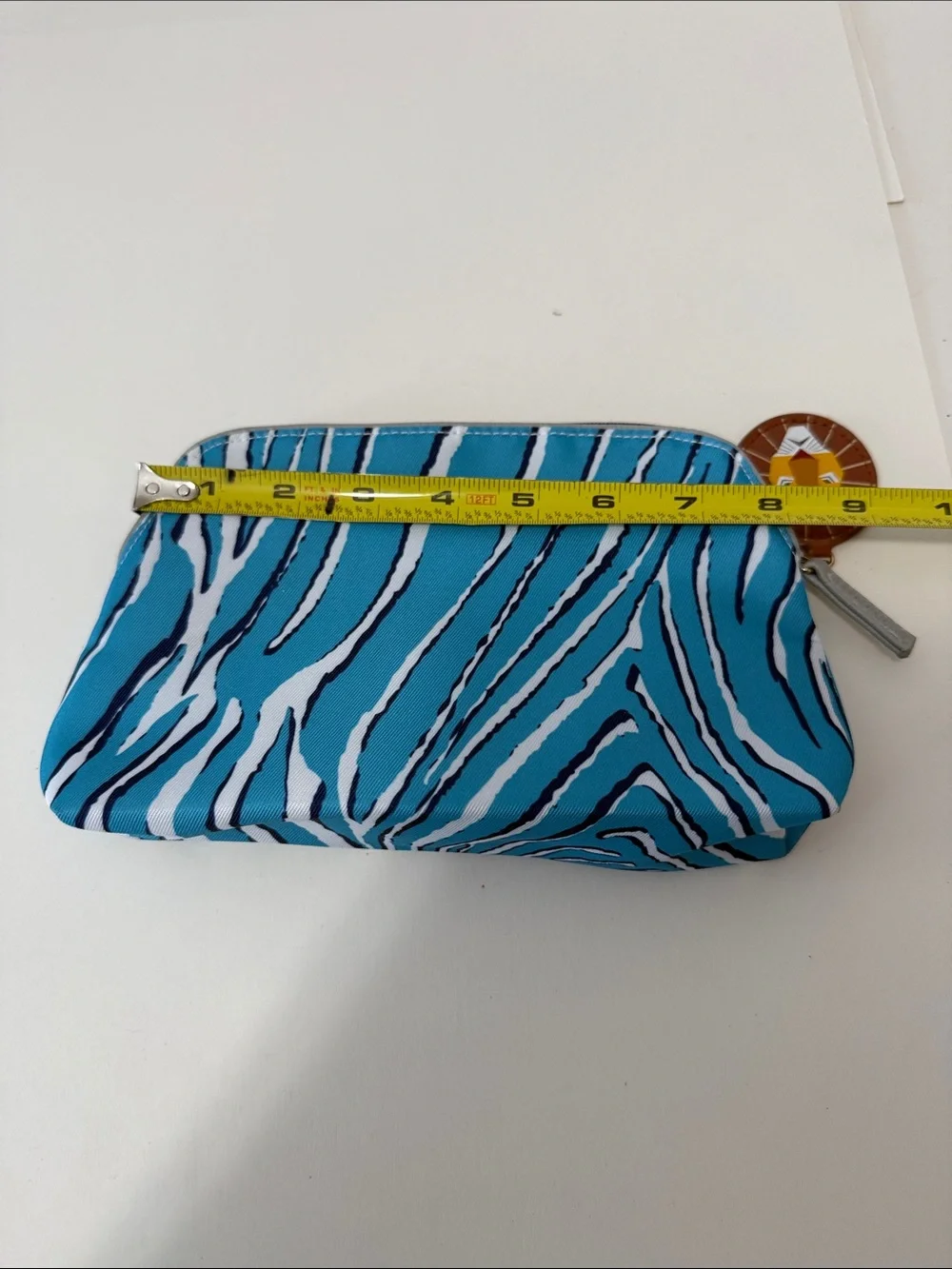 Estee Lauder Turquoise and White Zebra-Print Cosmetic Pouch with Lion Charm